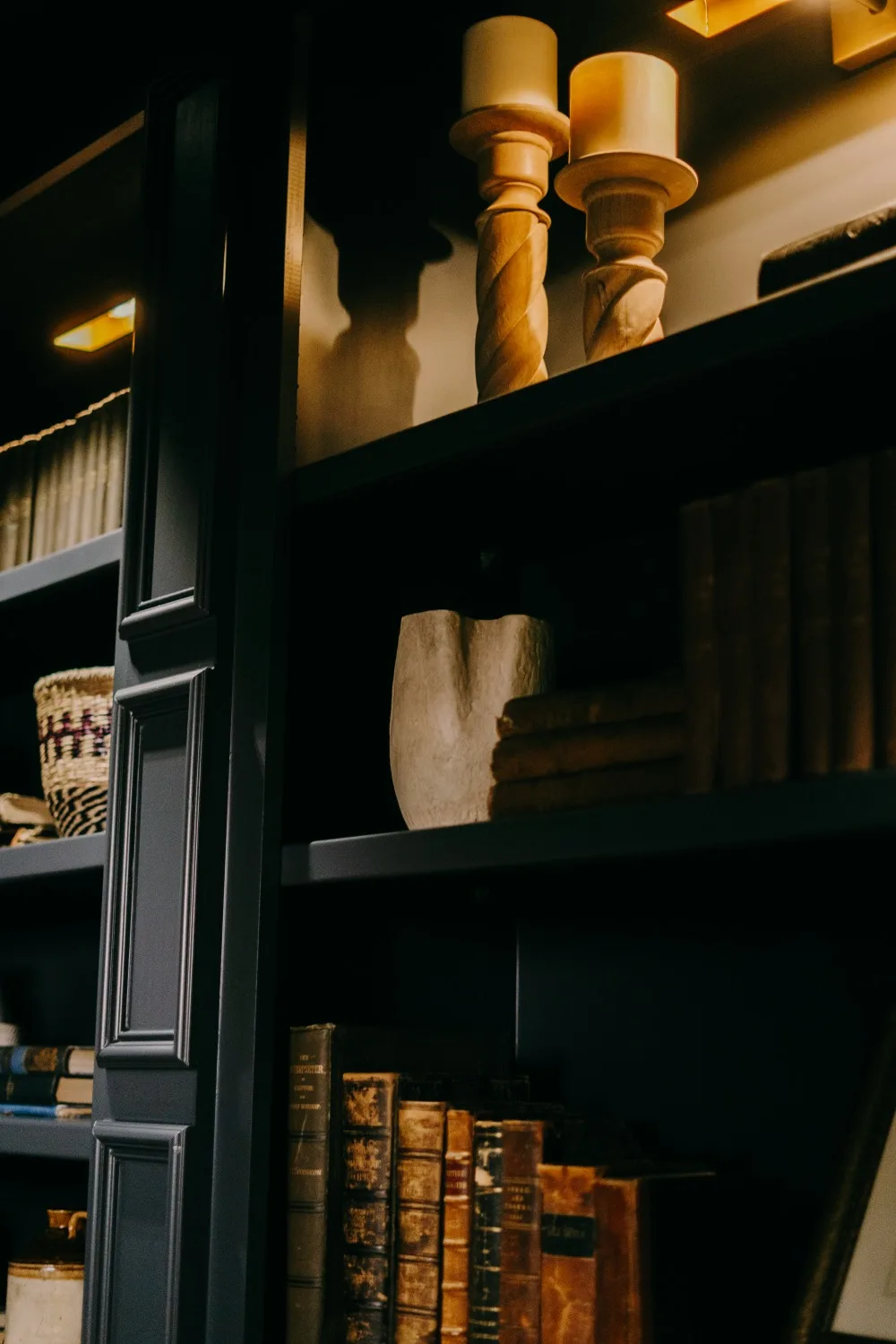 Candlesticks and books on the studio shelves