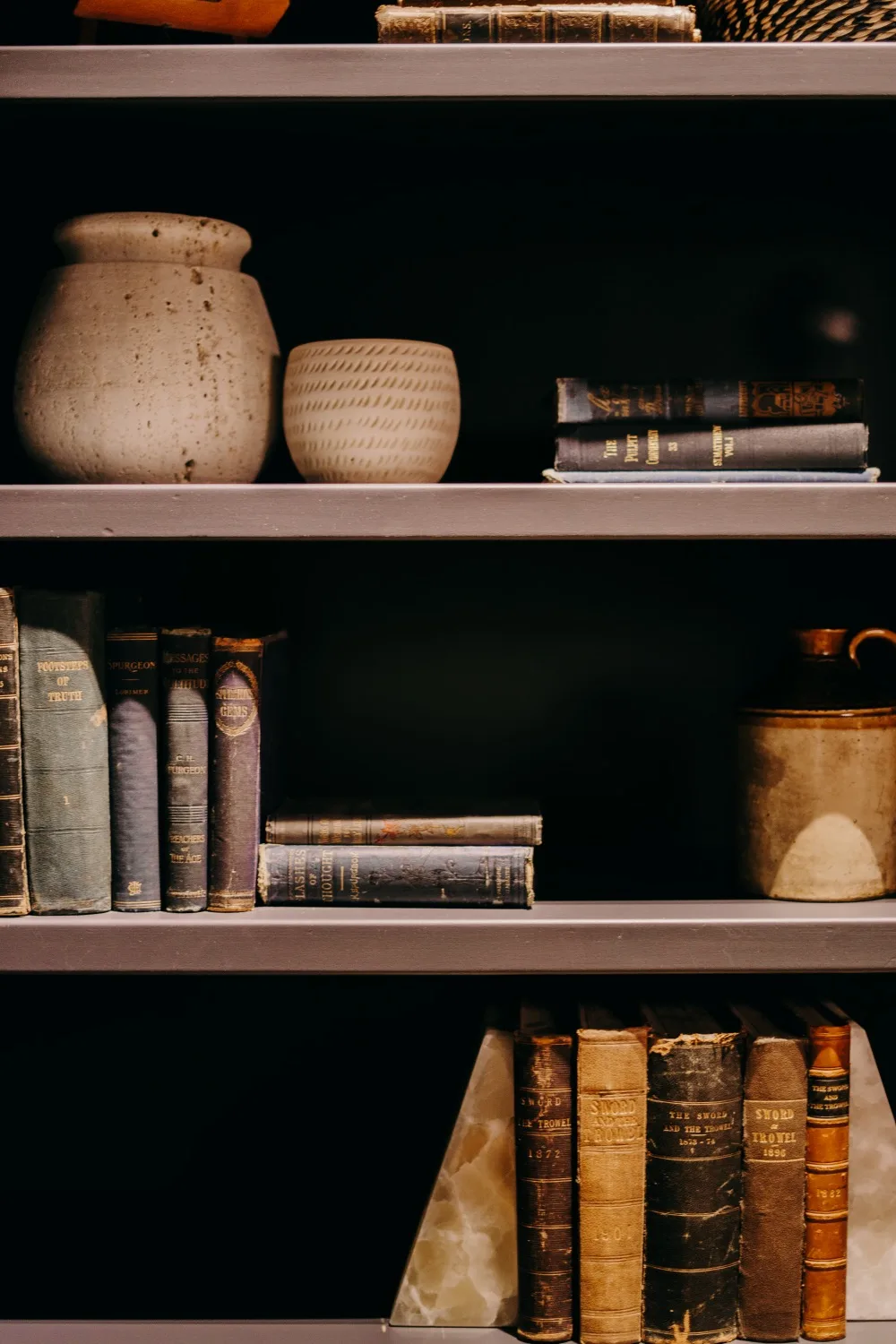 Pottery and old books on the studio shelves
