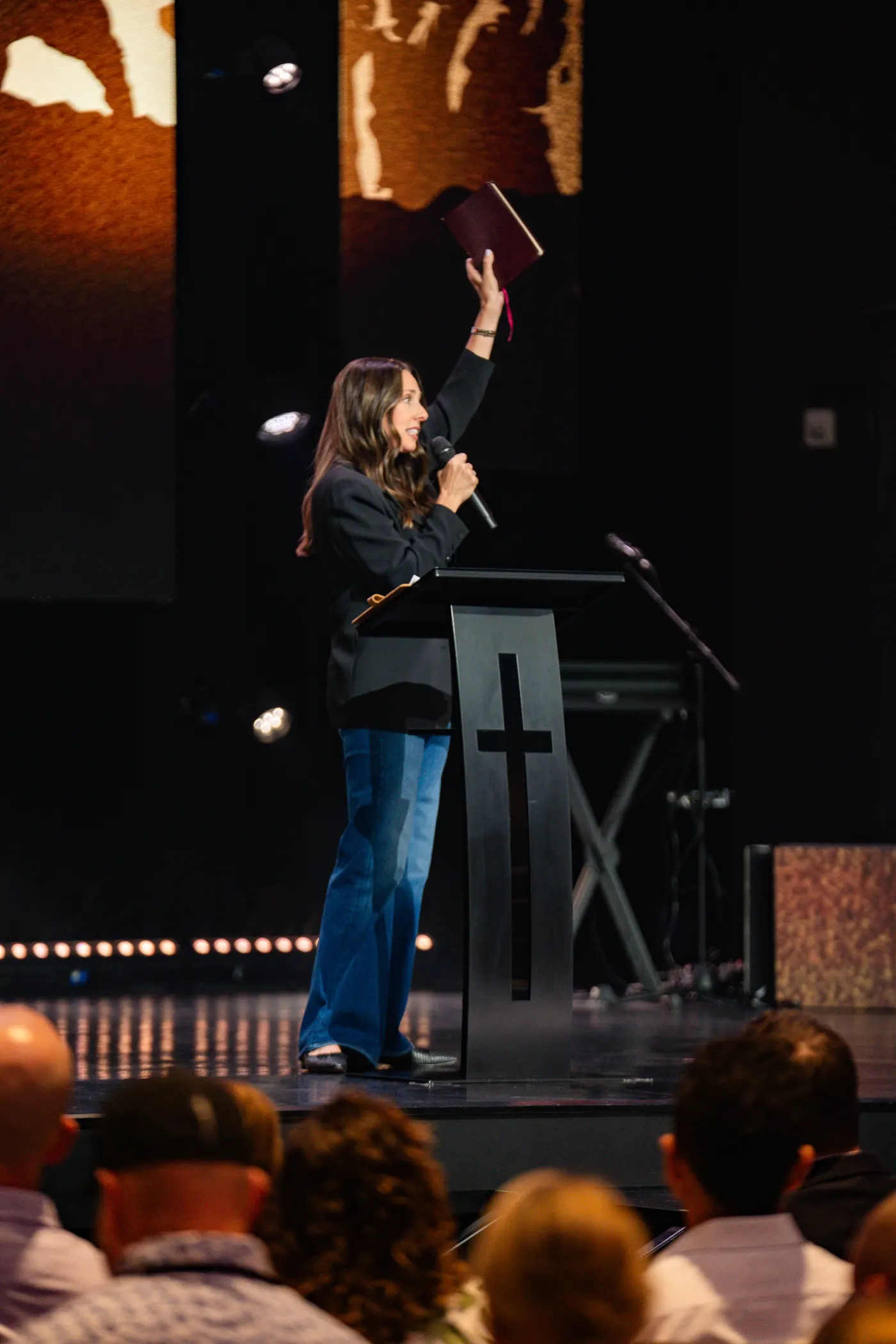 Susan Thomas teaching, holding up a Bible